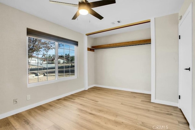 unfurnished bedroom with ceiling fan, a closet, and light hardwood / wood-style flooring