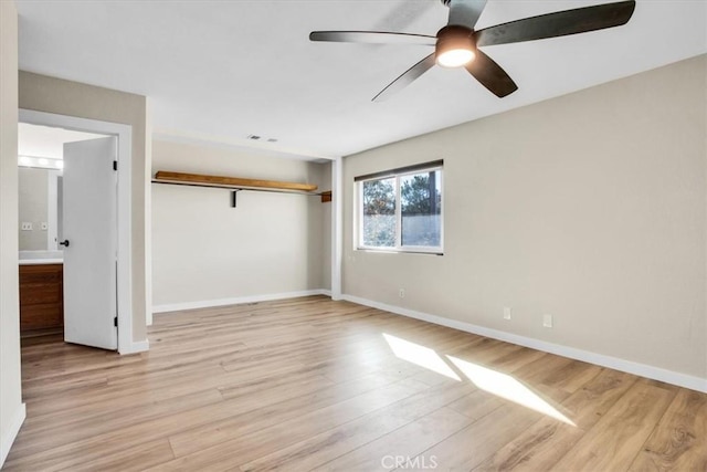 empty room featuring light hardwood / wood-style flooring and ceiling fan