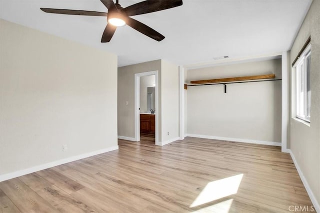 unfurnished bedroom featuring ensuite bath, ceiling fan, a closet, and light hardwood / wood-style floors