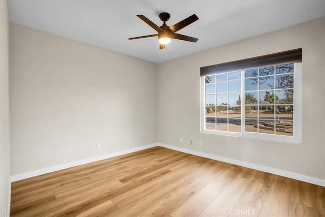 spare room with hardwood / wood-style flooring and ceiling fan