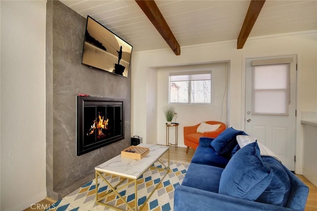 living room with wood-type flooring, a large fireplace, wood ceiling, and beam ceiling