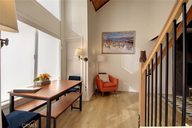 interior space featuring light wood-type flooring and high vaulted ceiling