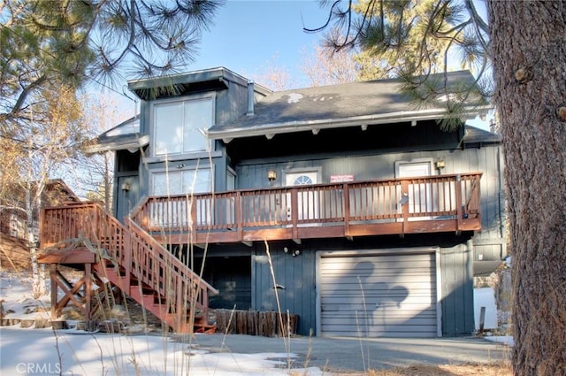 back of house featuring a wooden deck and a garage