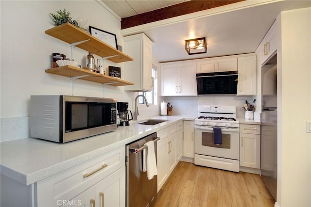 kitchen featuring white cabinets, sink, light hardwood / wood-style flooring, beam ceiling, and stainless steel appliances