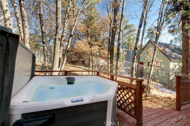 wooden deck featuring a hot tub