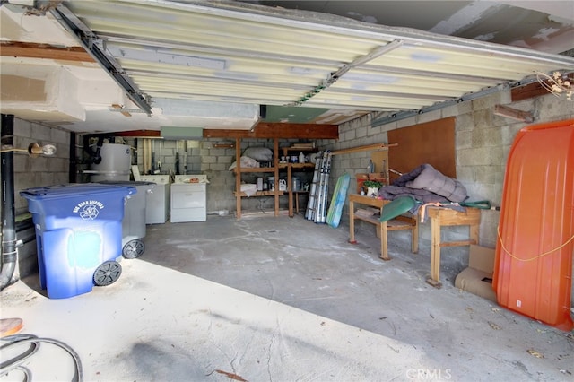 garage featuring gas water heater and separate washer and dryer