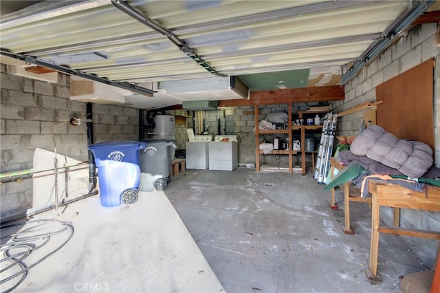 garage featuring gas water heater and independent washer and dryer