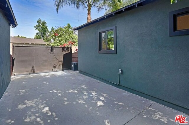 view of side of property featuring a patio area