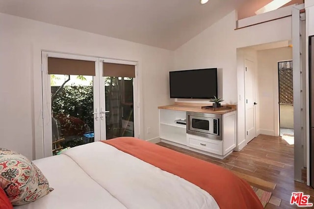 bedroom featuring lofted ceiling, access to outside, french doors, and light wood-type flooring