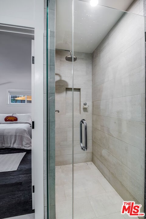 bathroom featuring a shower with door