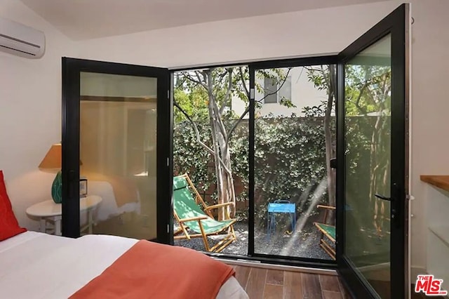 bedroom with a closet, a wall mounted air conditioner, and hardwood / wood-style floors