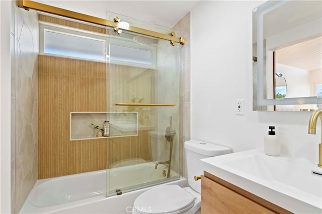 full bathroom with vanity, toilet, and bath / shower combo with glass door