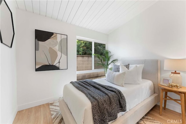 bedroom featuring wood-type flooring and wood ceiling