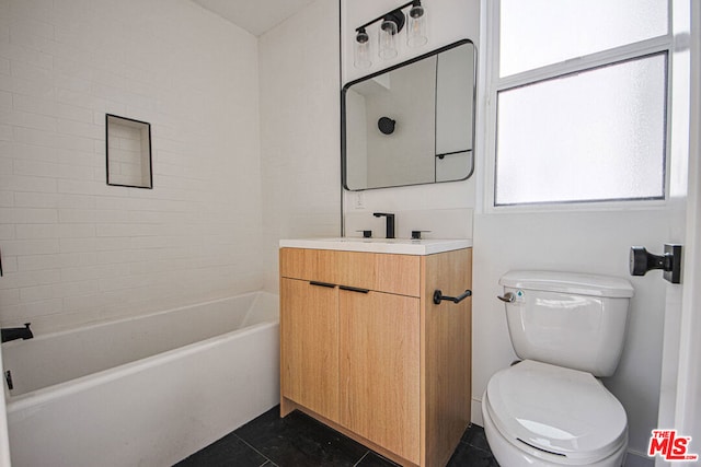 full bathroom featuring tile patterned floors, vanity, toilet, and tiled shower / bath