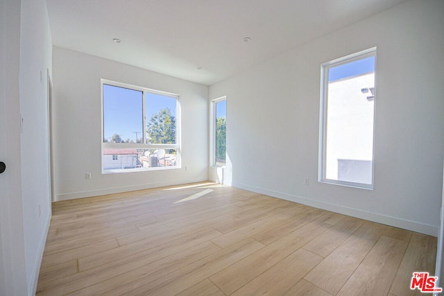 unfurnished room featuring light hardwood / wood-style flooring