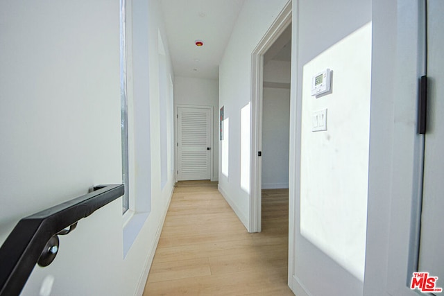 hallway with light hardwood / wood-style flooring