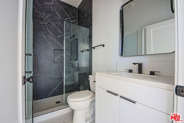 bathroom with a shower with door, vanity, and toilet