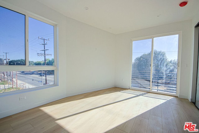 spare room with light wood-type flooring