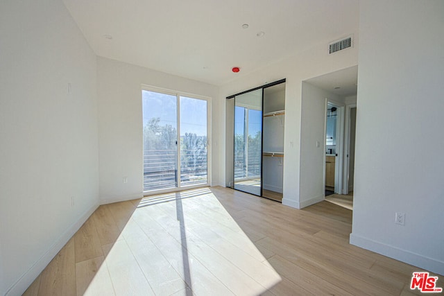 unfurnished room with light hardwood / wood-style flooring