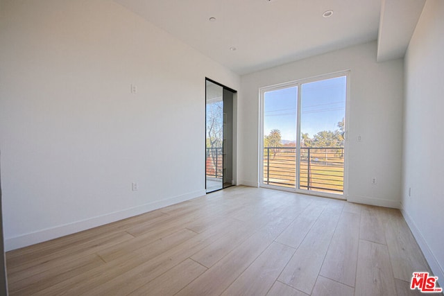 spare room with light wood-type flooring