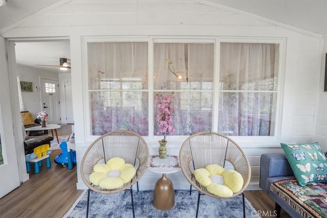 living area featuring lofted ceiling, ceiling fan, hardwood / wood-style floors, and plenty of natural light