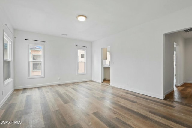 empty room with hardwood / wood-style flooring