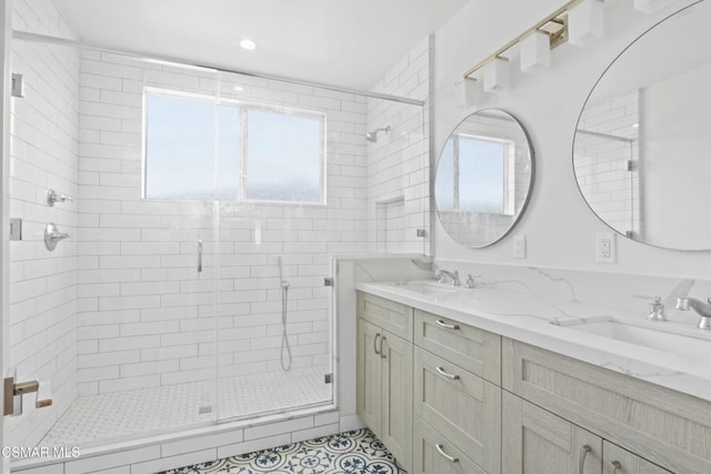 bathroom featuring tile patterned flooring, vanity, and a shower with shower door