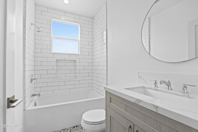 full bathroom featuring vanity, tiled shower / bath combo, and toilet