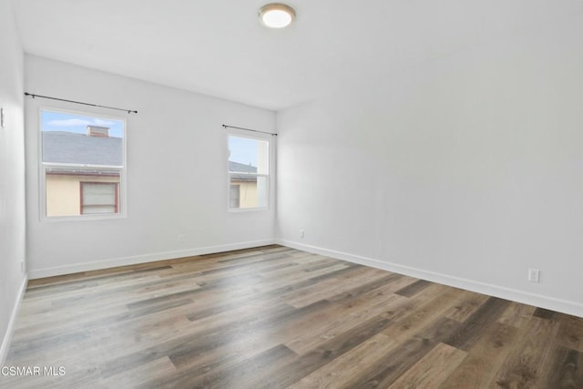 empty room featuring hardwood / wood-style floors and plenty of natural light