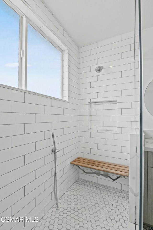 bathroom with a tile shower