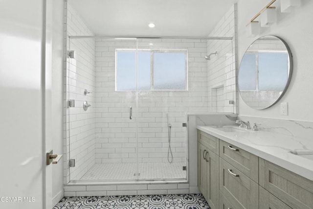 bathroom featuring tile patterned flooring, vanity, and a shower with door