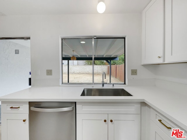 kitchen with white cabinetry, dishwasher, and sink