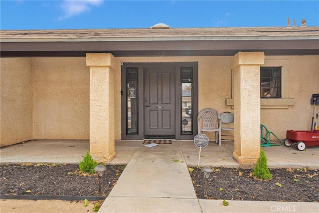 doorway to property with a porch