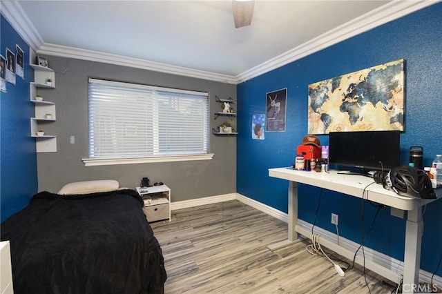 bedroom featuring hardwood / wood-style flooring, ceiling fan, and ornamental molding