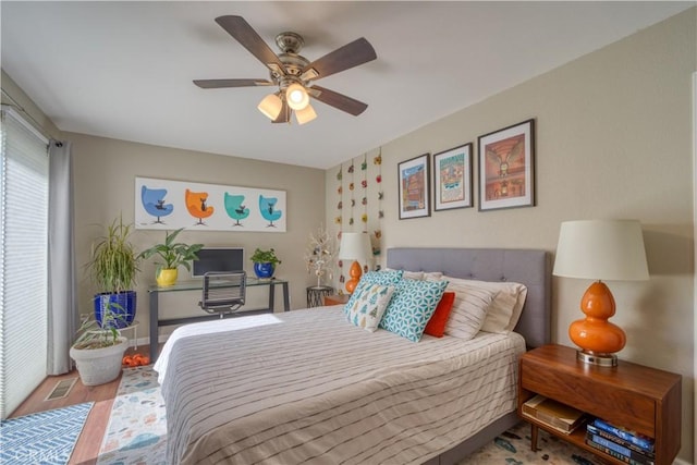 bedroom with ceiling fan and wood-type flooring