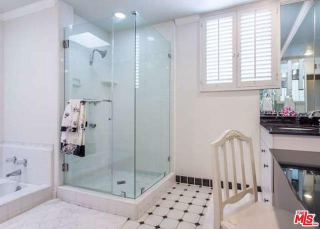 bathroom with separate shower and tub, crown molding, and sink