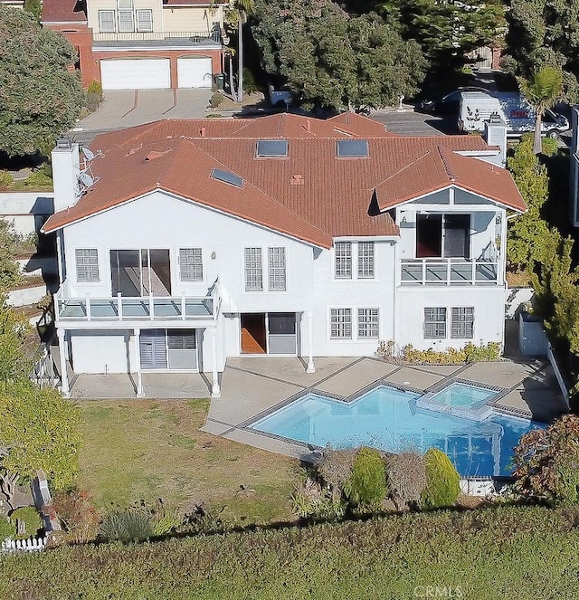 rear view of property with a balcony