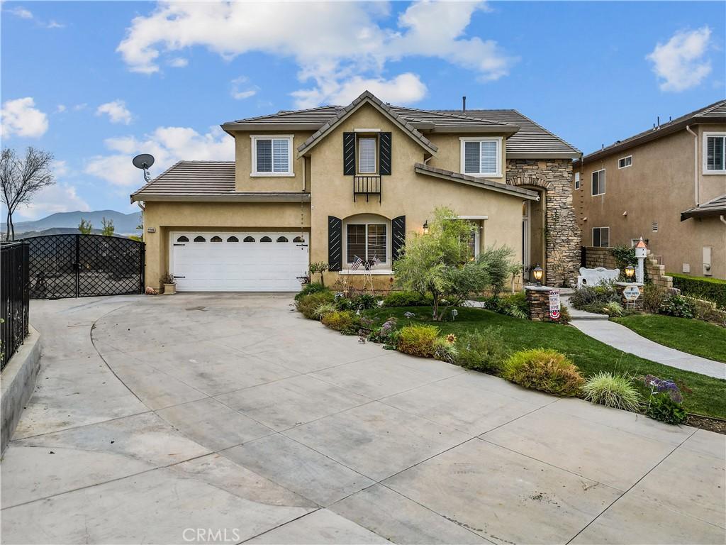 front facade with a mountain view and a garage