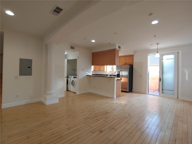 kitchen with washing machine and clothes dryer, light hardwood / wood-style flooring, decorative columns, electric panel, and stainless steel fridge