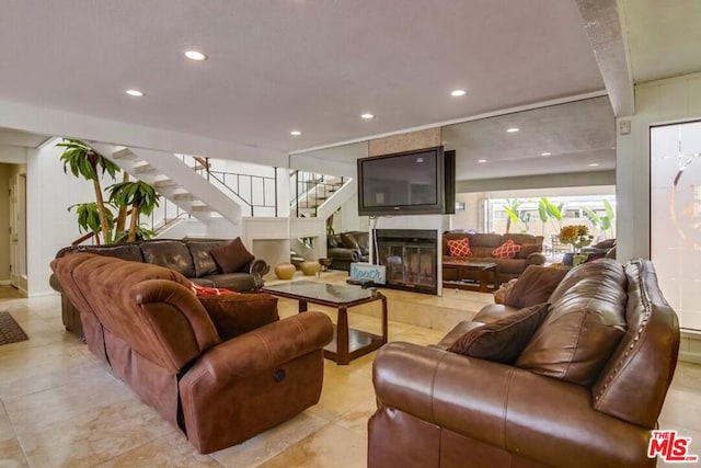 living room featuring a fireplace and light tile patterned floors