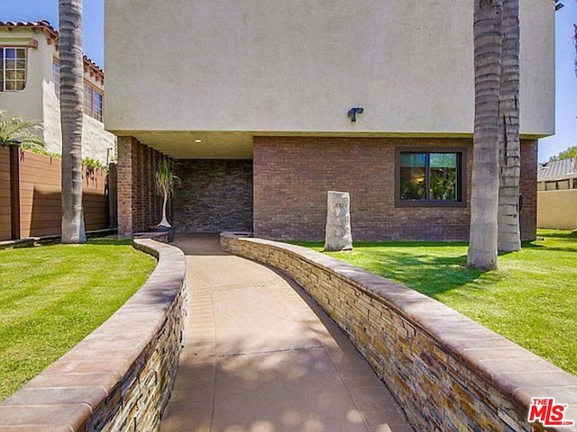 entrance to property featuring a yard