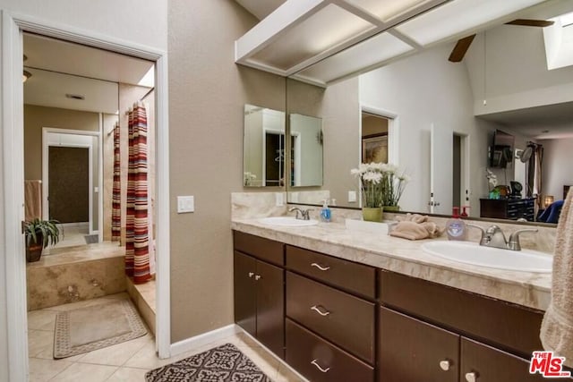 bathroom with tile patterned floors, vanity, a shower with shower curtain, and vaulted ceiling