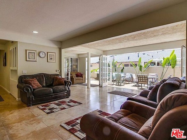 living room featuring a textured ceiling and light tile patterned flooring