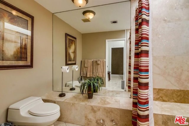 bathroom featuring tile patterned floors and toilet