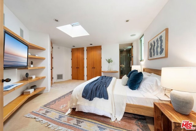 carpeted bedroom featuring a skylight