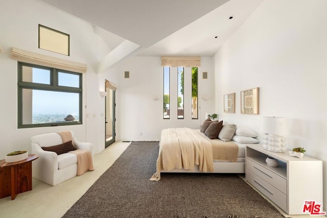 bedroom with light carpet and high vaulted ceiling