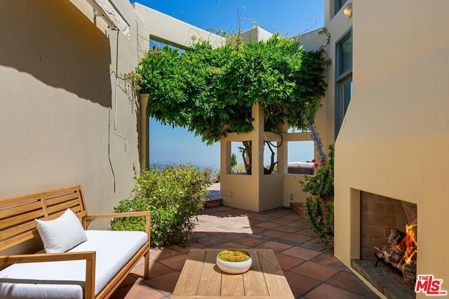 view of patio featuring exterior fireplace