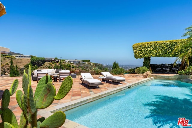 view of pool featuring an outdoor hangout area and a patio