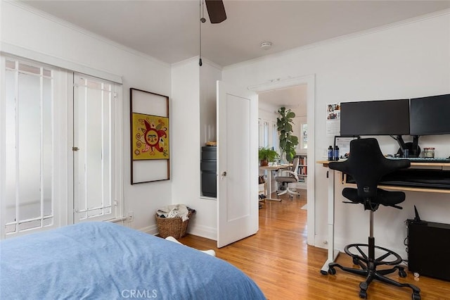 bedroom with ceiling fan, light hardwood / wood-style flooring, and crown molding