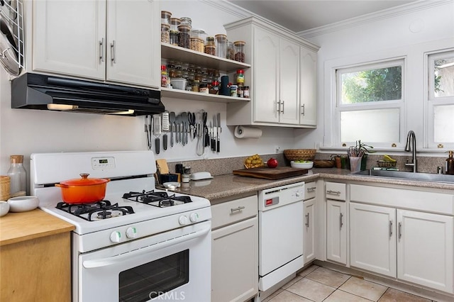 kitchen featuring white appliances, white cabinets, crown molding, sink, and light tile patterned flooring